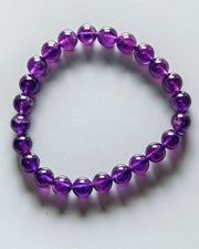 Purple beaded bracelet on a white background